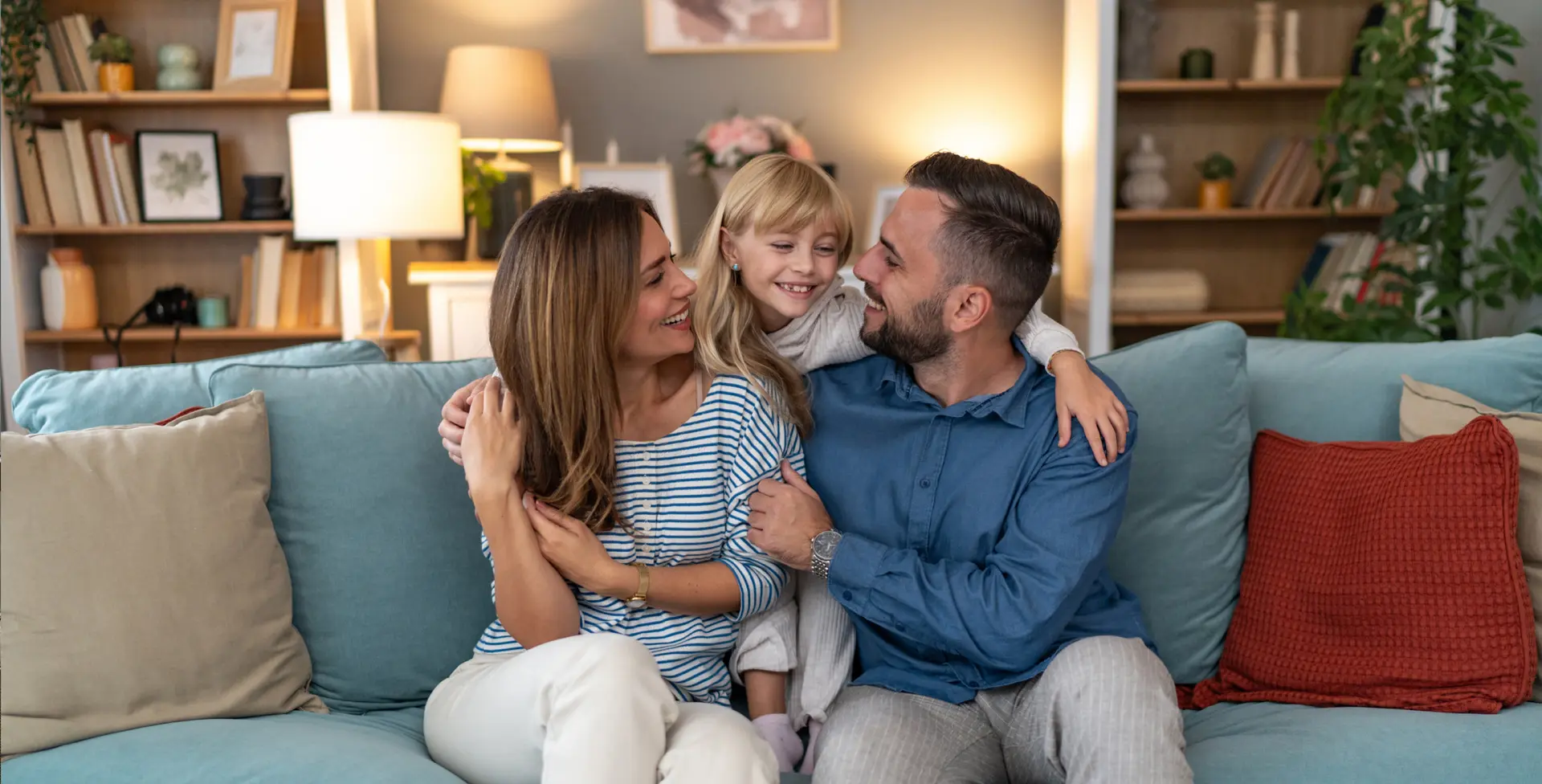Family seated together in a dimly lit living room