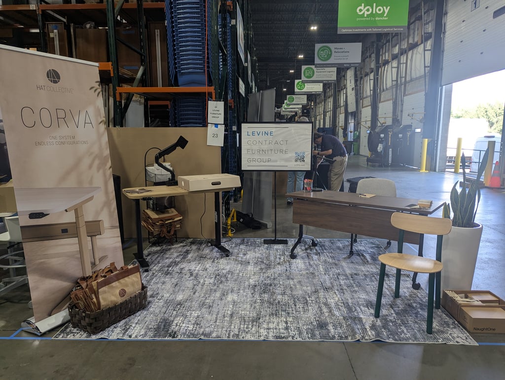 The Corva banner reading One System Endless Configurations beside the Levine Contract Furniture Group sign
