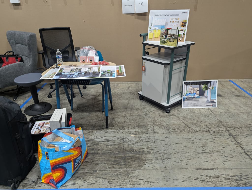 A Paragon exhibit with an Early Elementary Classroom poster and a School Lounge Soft Seating floor poster