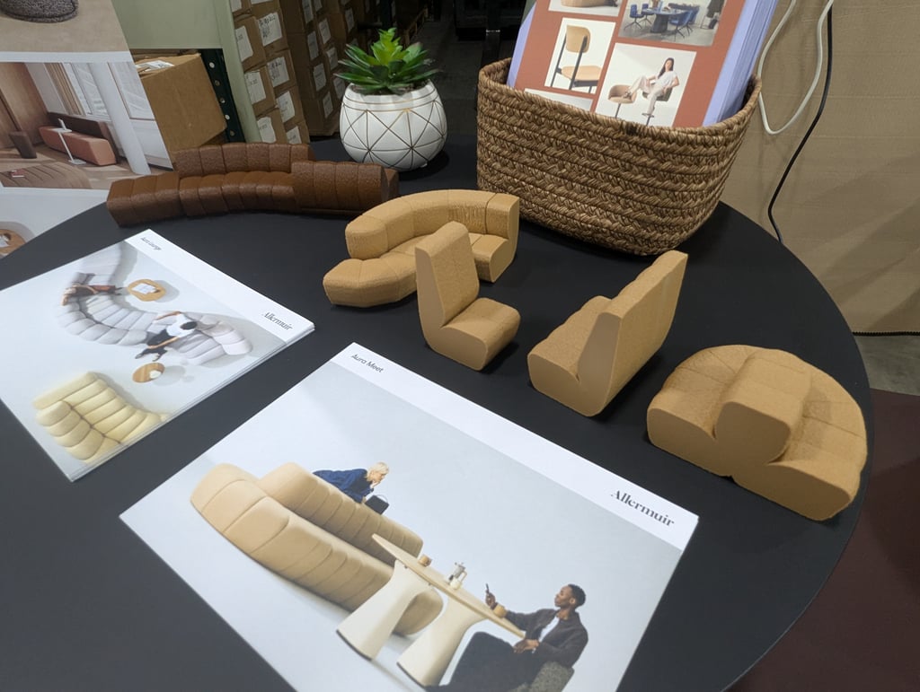 Scale models of curved modular seating and Allermuir brochures on a round table