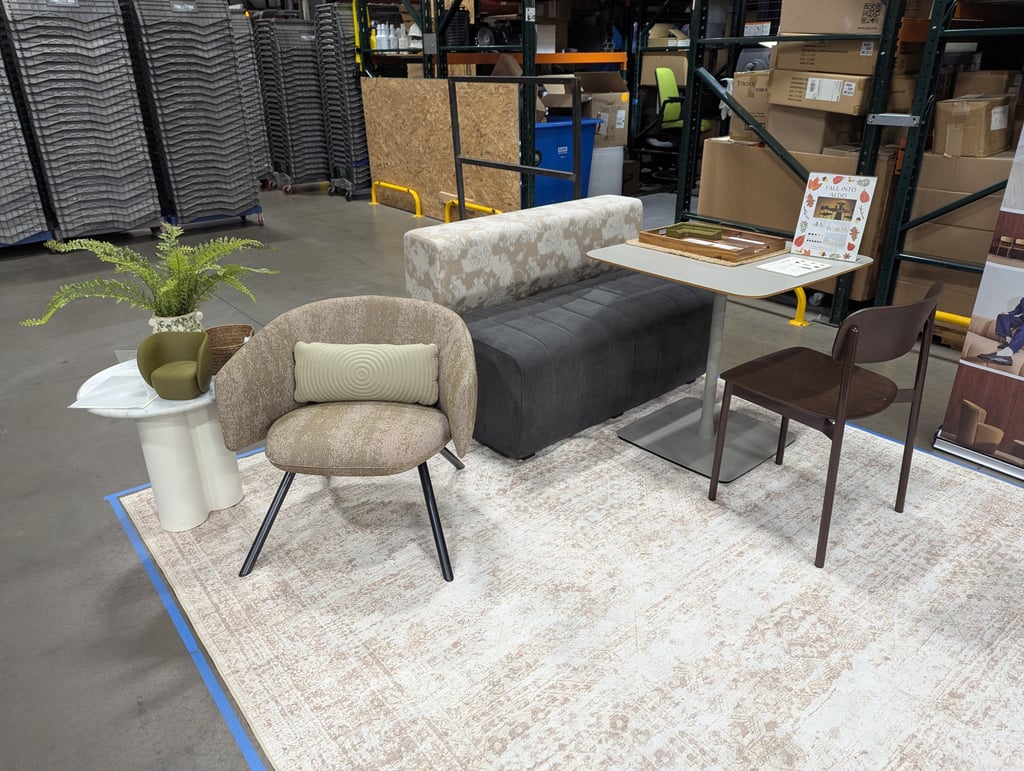 A seating vignette of chairs and a bench on a patterned rug at the Aldo display