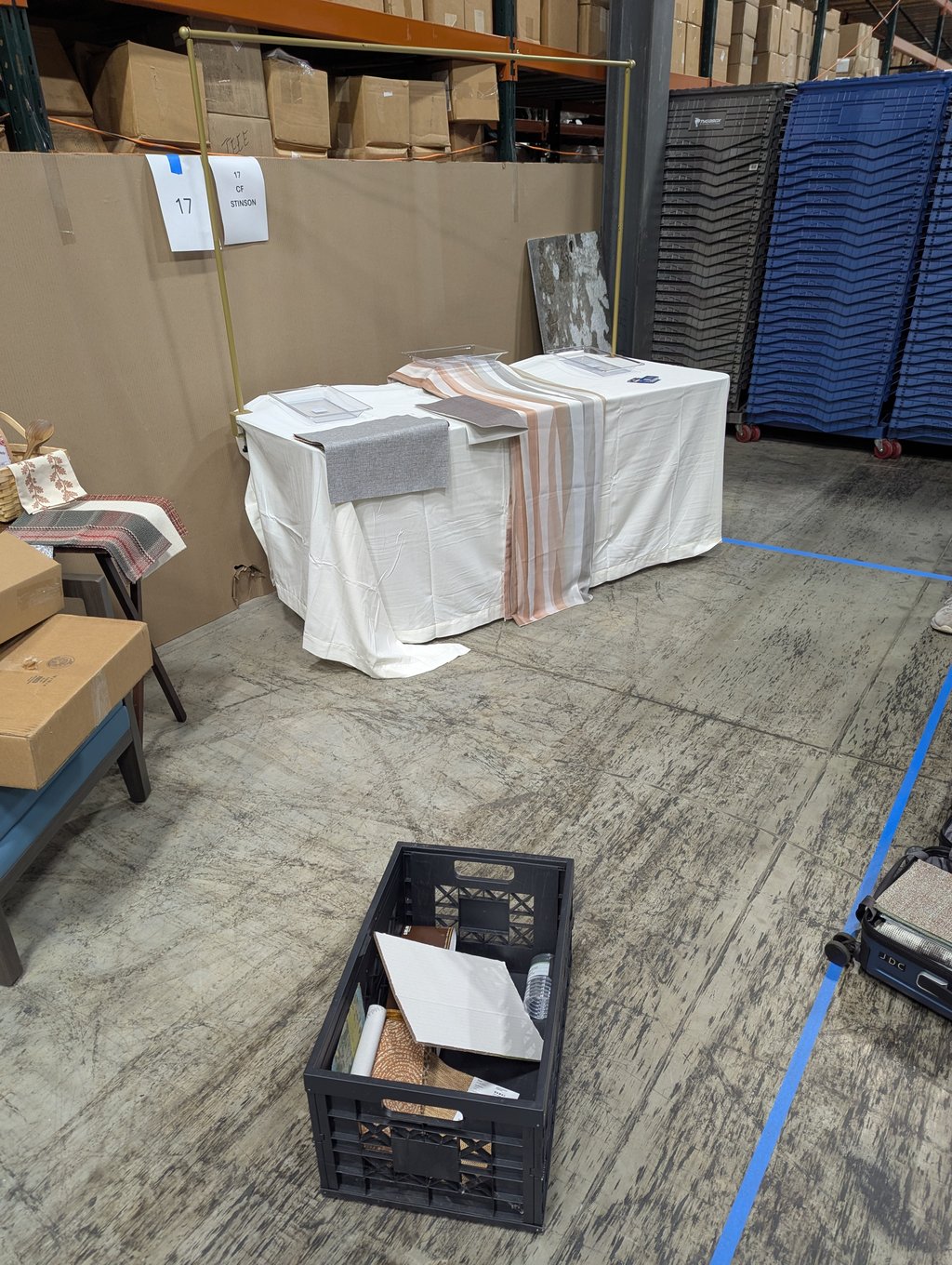 The CF Stinson booth at number 17 with material sample trays on a draped table