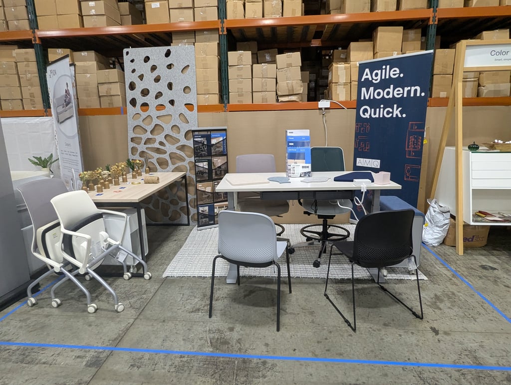 Office furniture staged in front of a large Agile Modern Quick banner
