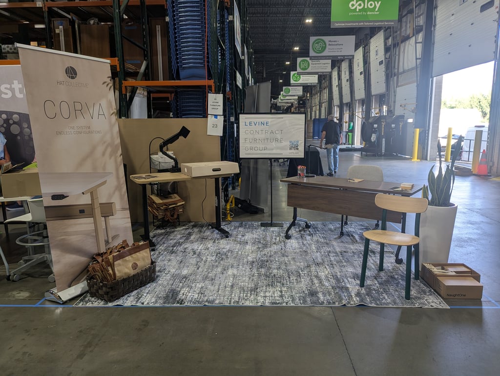 The Corva and Levine stand with desks, chairs and a rug set up by the loading bays