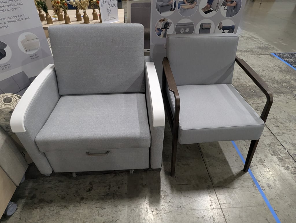 Two grey chairs with contrasting armrests standing beside the flower bar sign