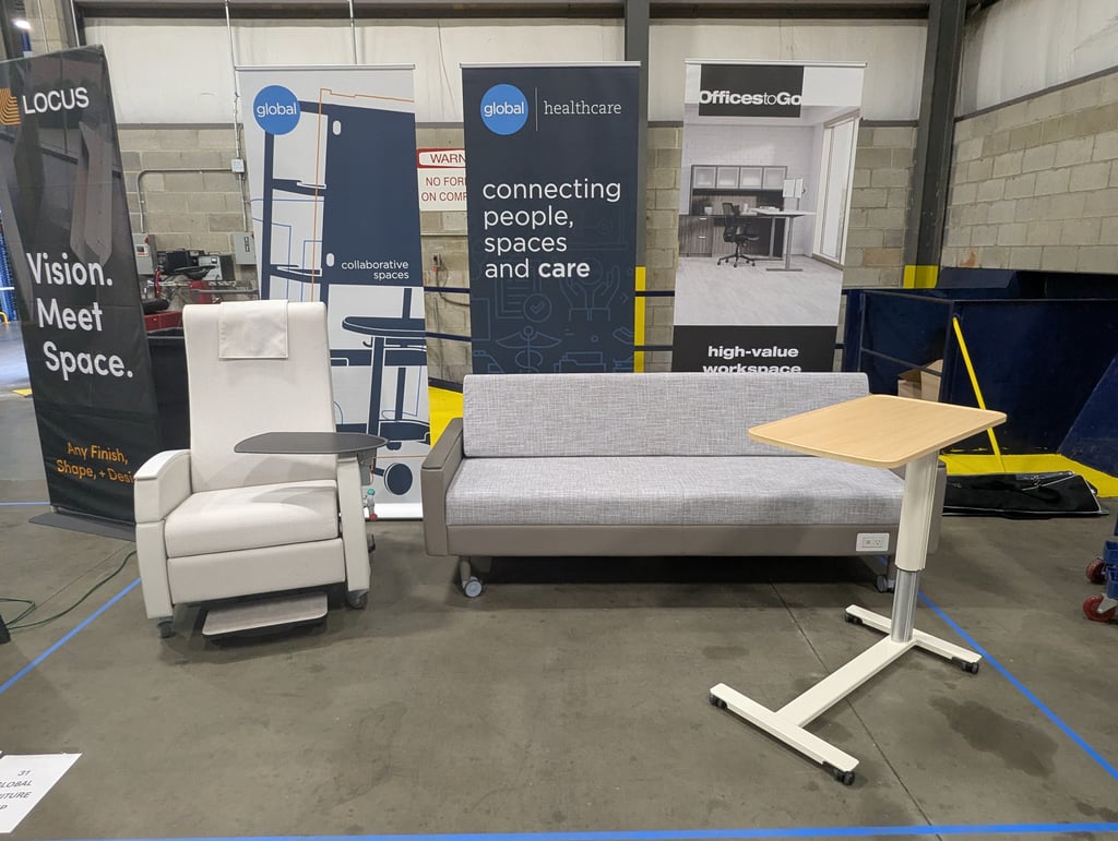 A row of exhibitor banners for Locus, Global healthcare and OfficesToGo across the floor