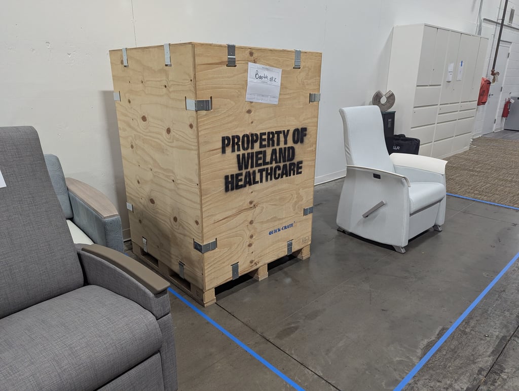 A Wieland Healthcare shipping crate labelled for booth 2 waiting on a pallet