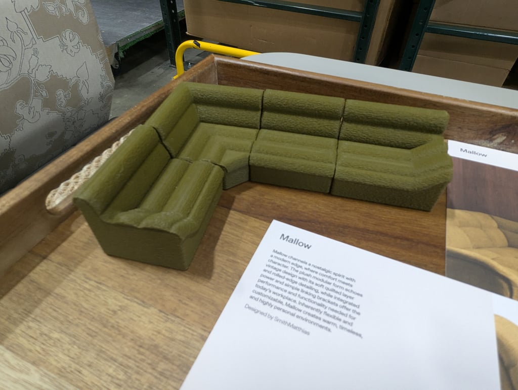 A small olive-green Mallow sectional model displayed in a wooden tray