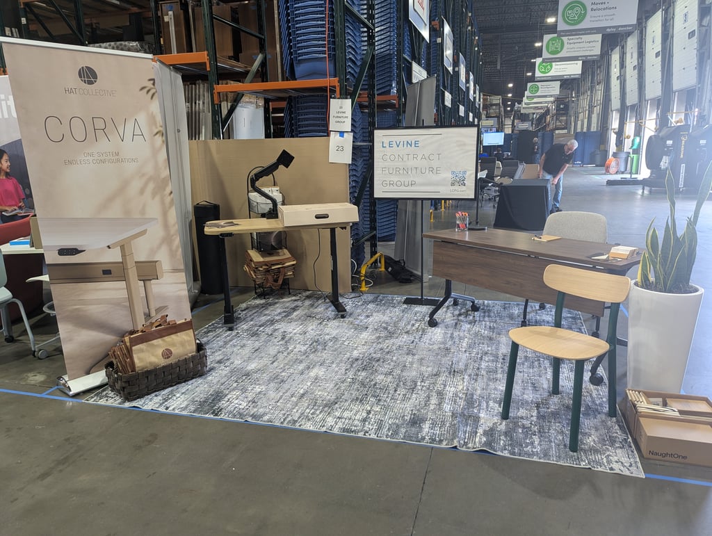 A Corva workspace vignette of desks and chairs on a large rug beneath the Levine sign