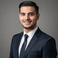 Professional headshot of a man in a navy suit