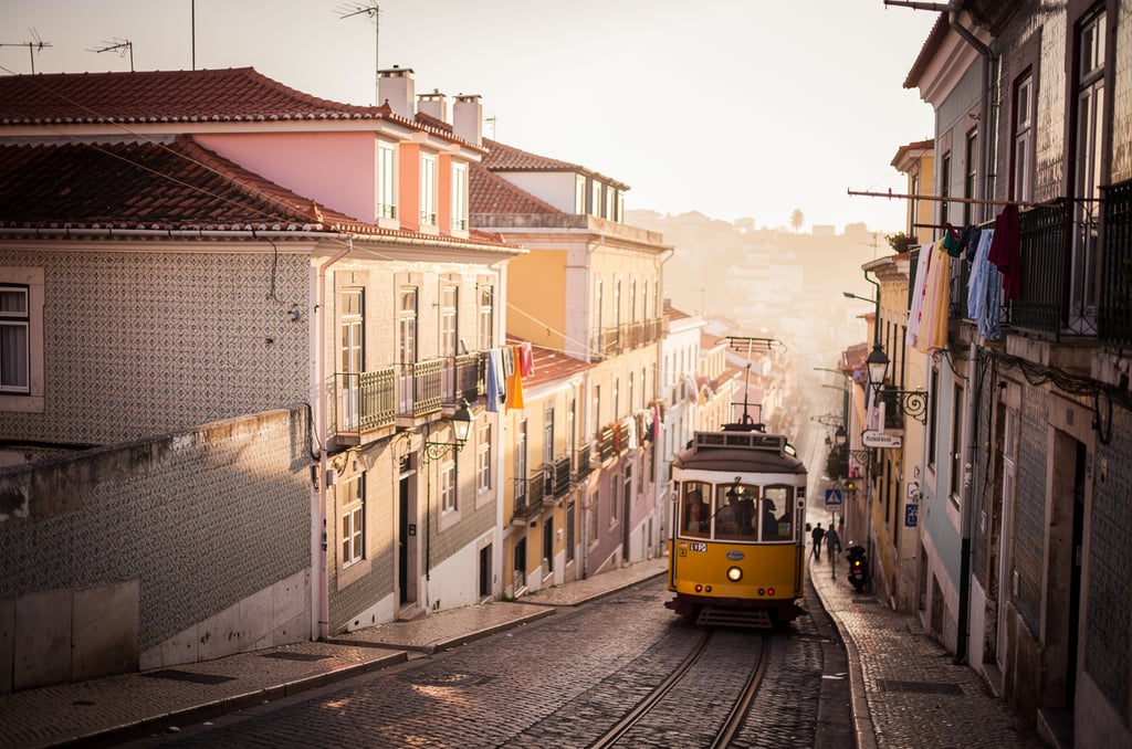 Lisbon Alfama rooftops with yellow tram