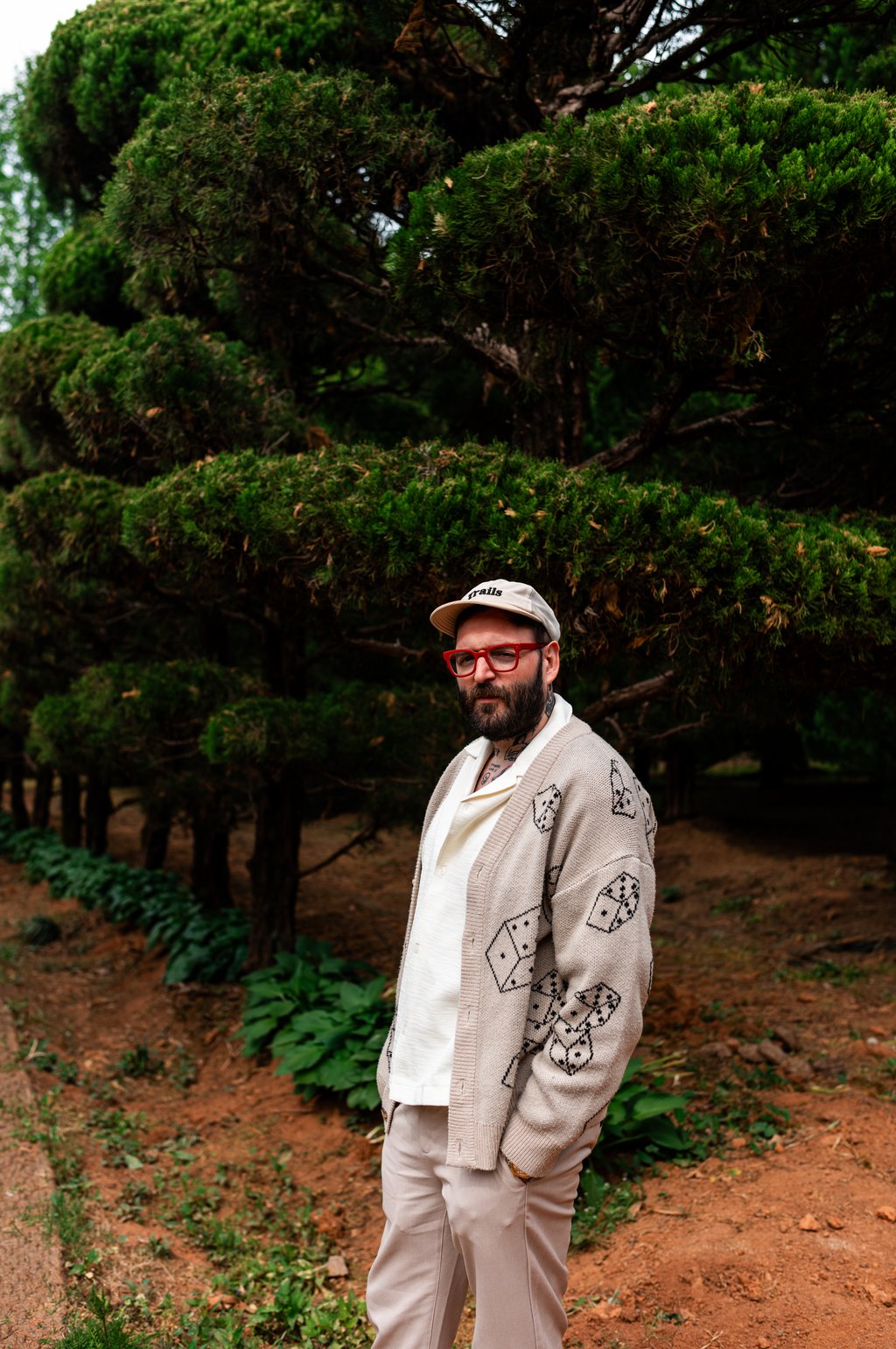 Portrait of Jack Dixon standing among lush green foliage