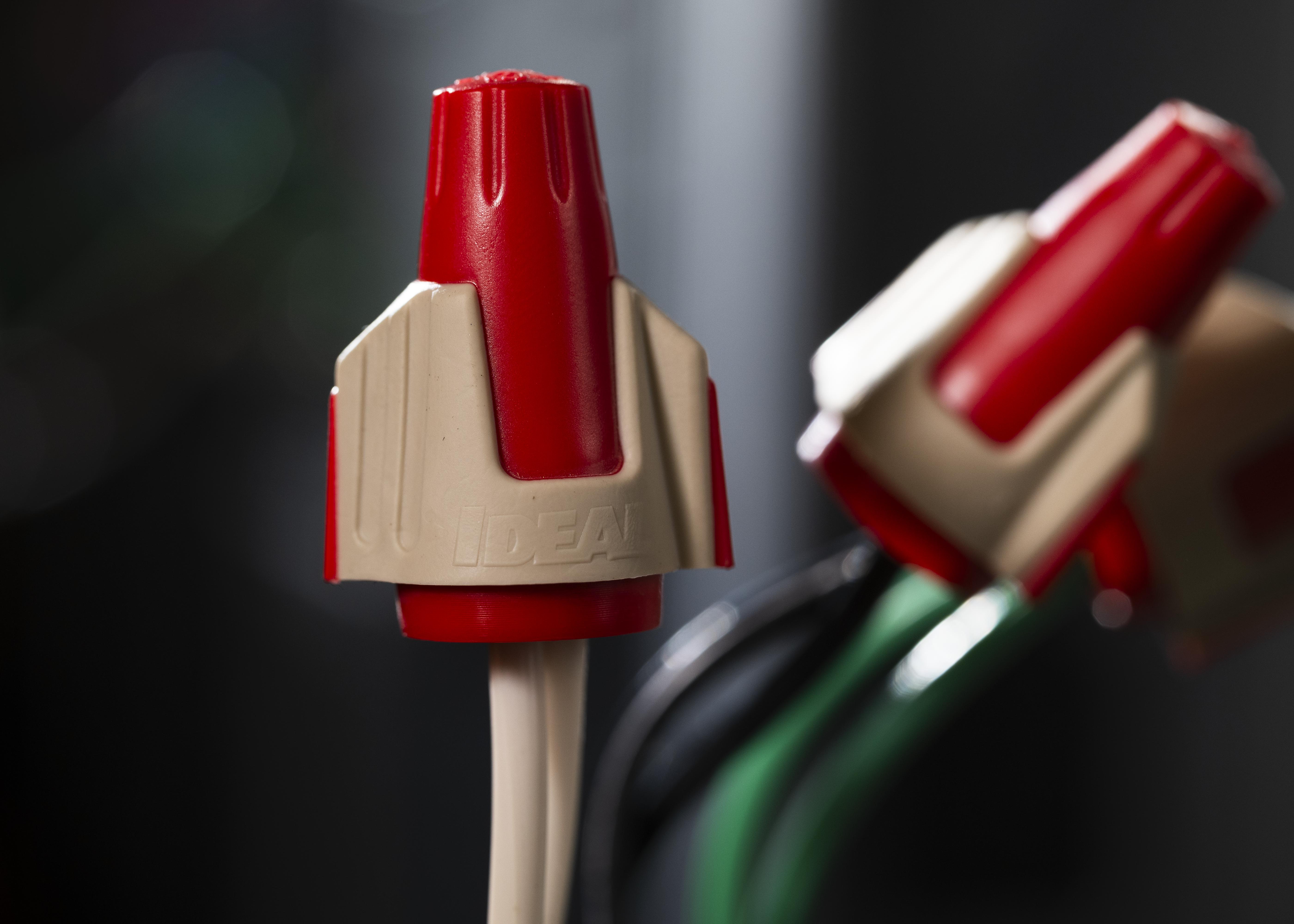 An IDEAL Twister Pro in use on an electrical wire.
