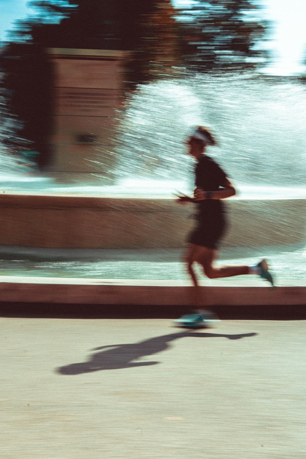 Runner mid-stride past a fountain