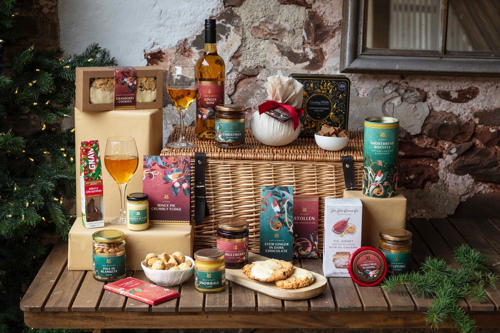 Festive hamper filled with seasonal treats, including Jingleberry jam, savoury crackers, festive stollen, a chocolate bar and a Christmas pudding.