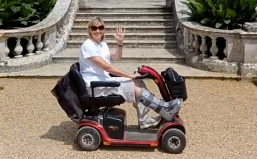 Lisa Harvey riding a mobility scooter at Kingston Lacy, Dorset.
