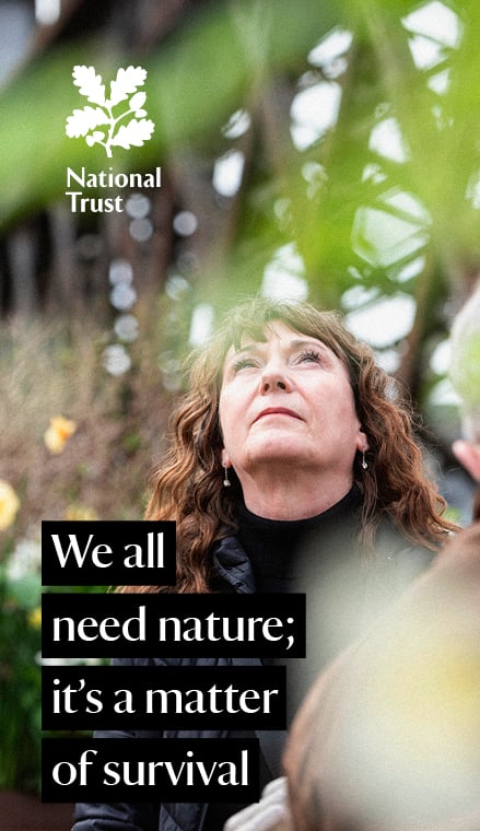 Close up of person staring up at sky with text that states. 'We all need nature; it's a matter of survival.'