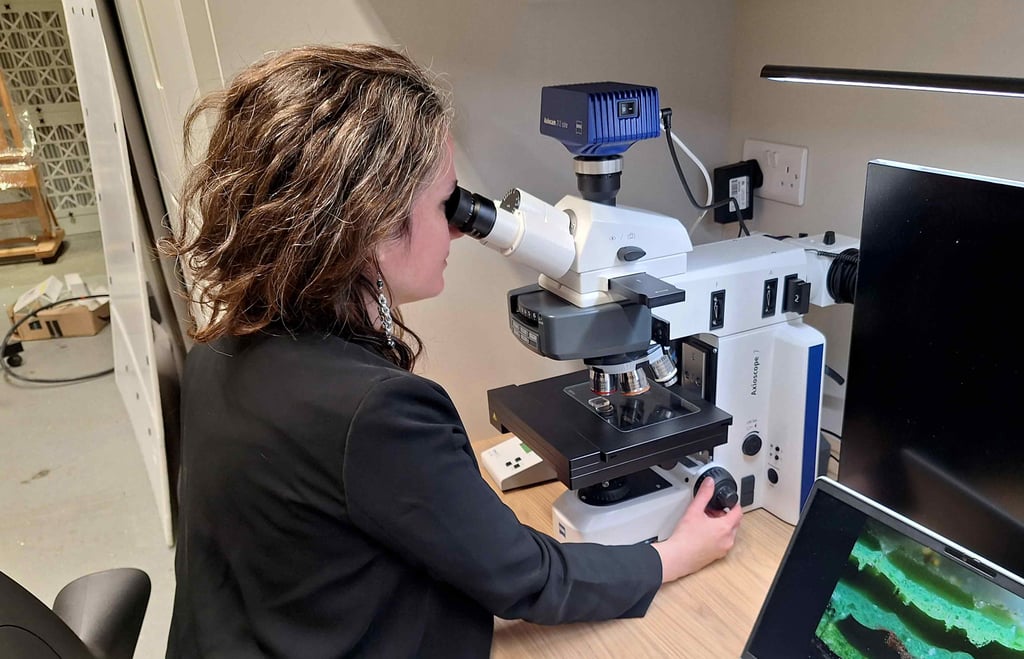Valentina looking through microscope.
