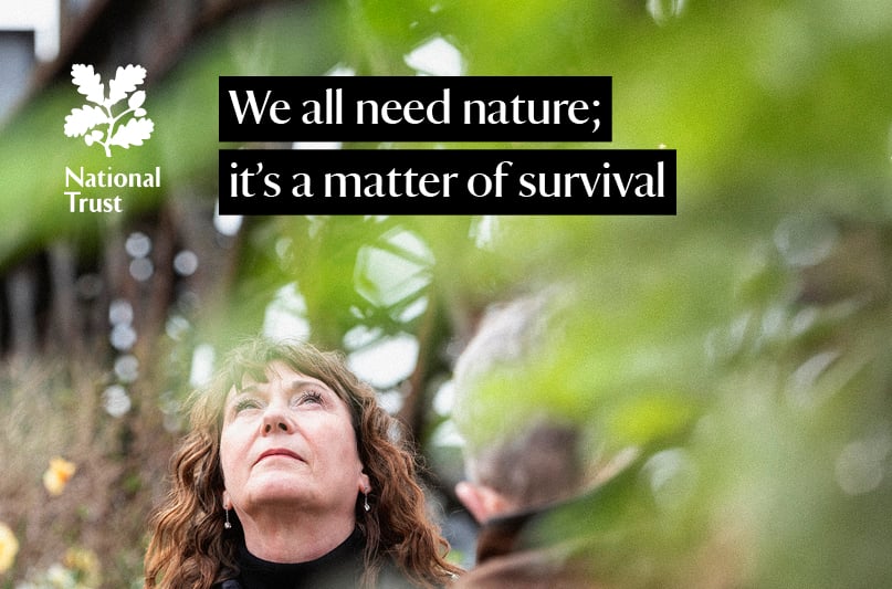 Close up of person staring up at sky with text that states. 'We all need nature; it's a matter of survival.'